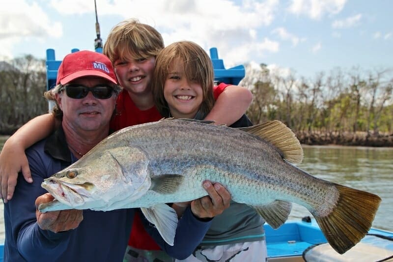 Kids catching barramundi